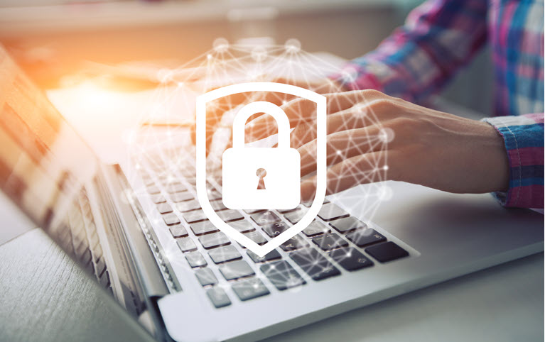 A person at a laptop with a padlock in front of it to represent safeguarding financial assets.