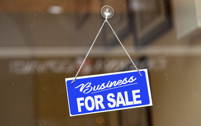 Image with a sign in blue and white saying: Business for sale.