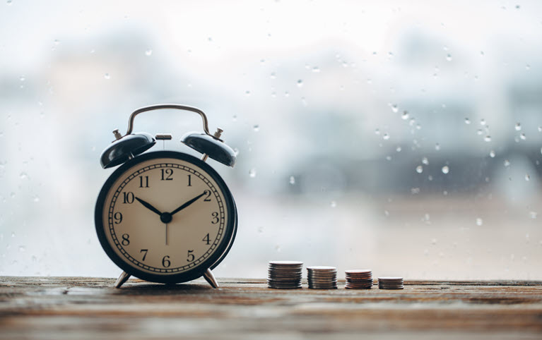 Insurance imaged by an alarm clock during a downpour