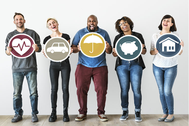Five people standing in a line holding circular signs with the followings images, a heart, a car, an umbrella, a piggy bank, a house.