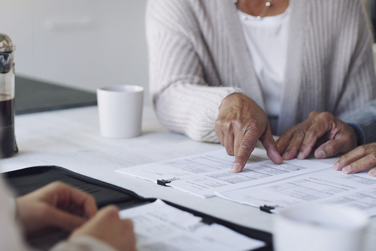 People around a table analyzing documents