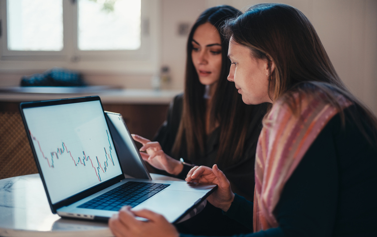 Image of two women going over their financial portfolio.