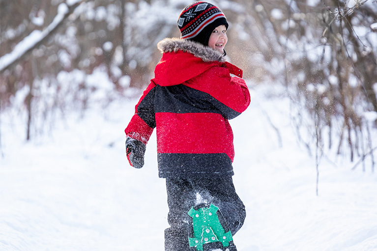 young boy snowshoeing