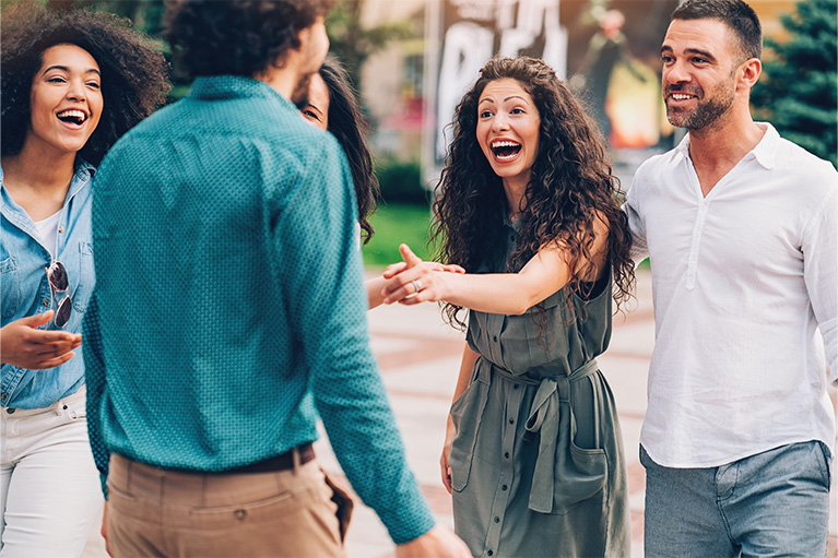 a group of 5 people meeting up on the street
