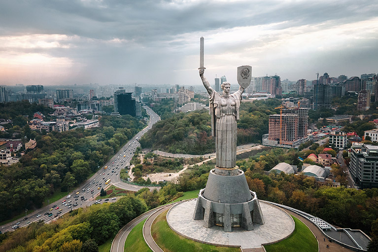 an overview of Kiev with the Motherland sculpture in the forefront