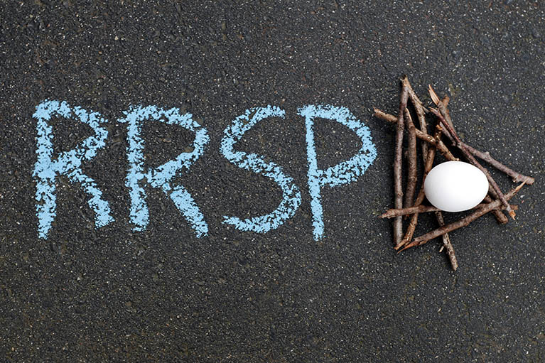 black chalkboard showing RRSP written in chalk with a nest with an egg in it beside words