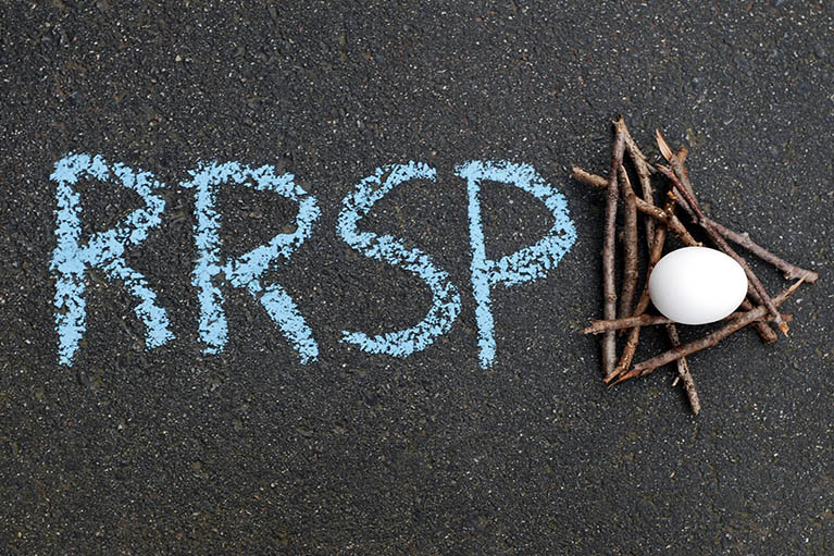 black chalkboard showing RRSP written in chalk with a nest with an egg in it beside words