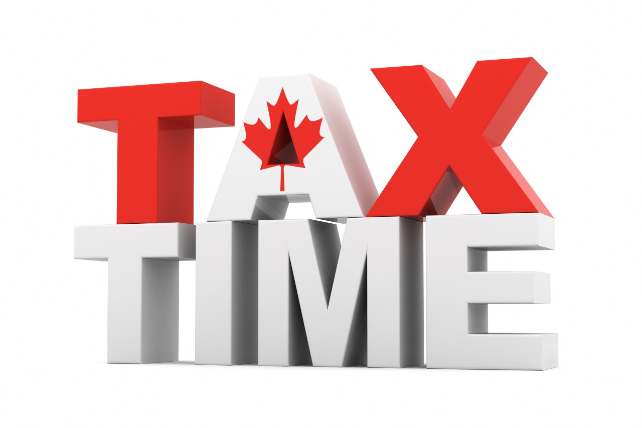 The word TAX with a maple leaf on it, stacked on top of the word TIME
