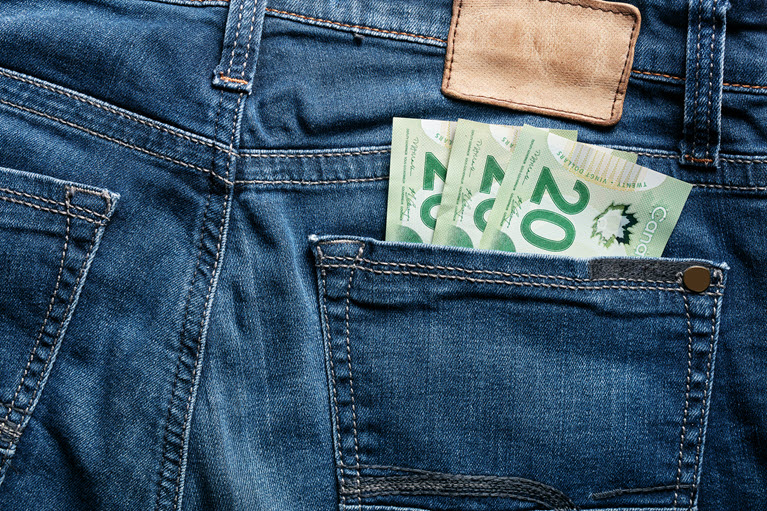 back pocket of jeans with dollar bills showing