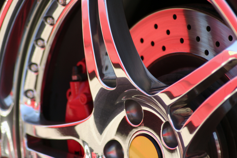 close up shot of a chrome exotic car rim
