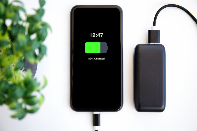 cell phone being charged with batter pack 
