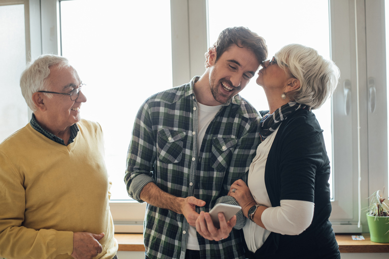 parents embracing adult son
