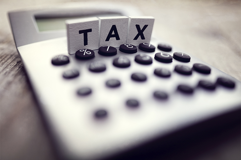 Image of a calculator with the word Tax written on it. 