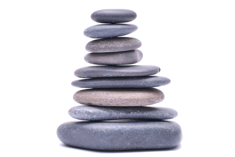 A stack of 9 grey pebbles on a white background.