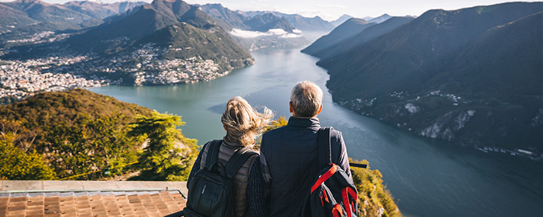 Couple admiring a lake at the top of a mountain