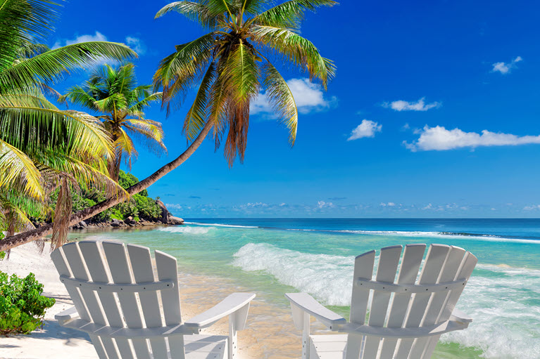 two chairs on a beach representing how we will work with you to reach your goals