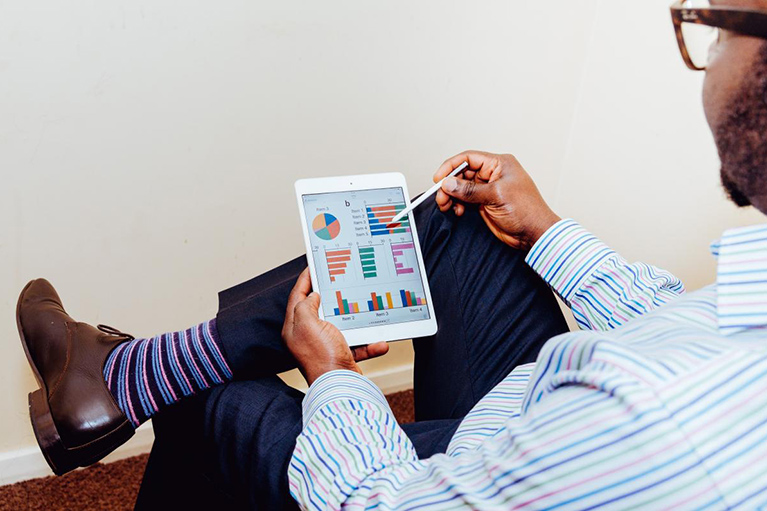 A man uses an electronic tablet.