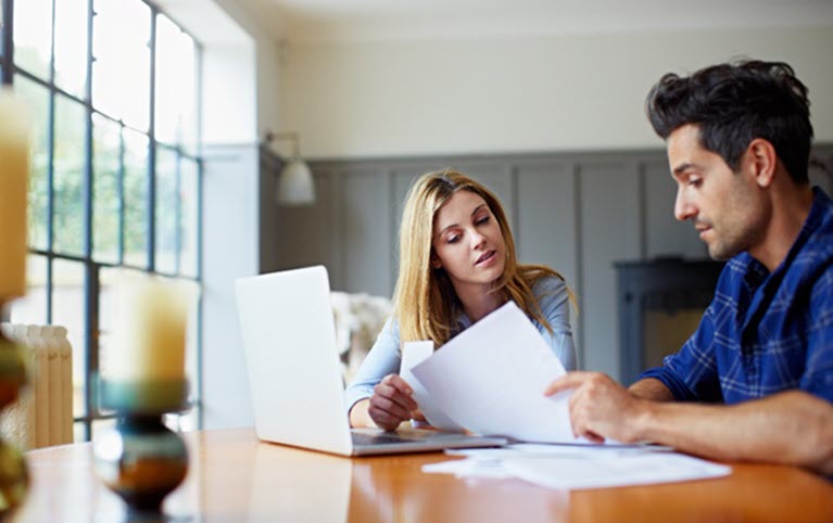 A couple discussing their life insurance documents. 