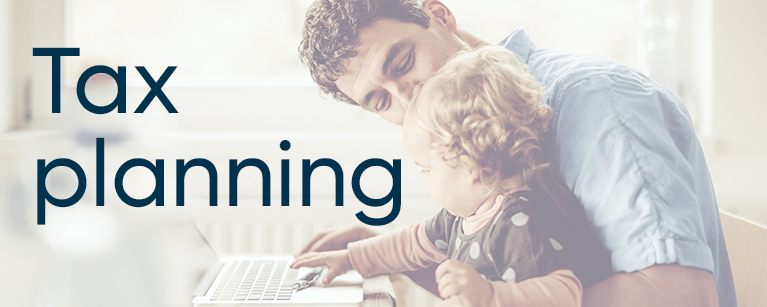 Image of a young father working at the computer with his child on him with the title Tax planning