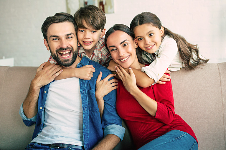 Young family sitting on sofa