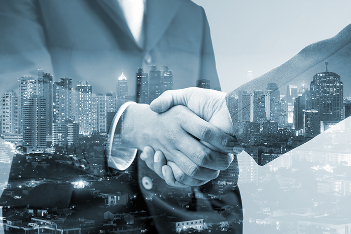 Handshake on front of buildings.