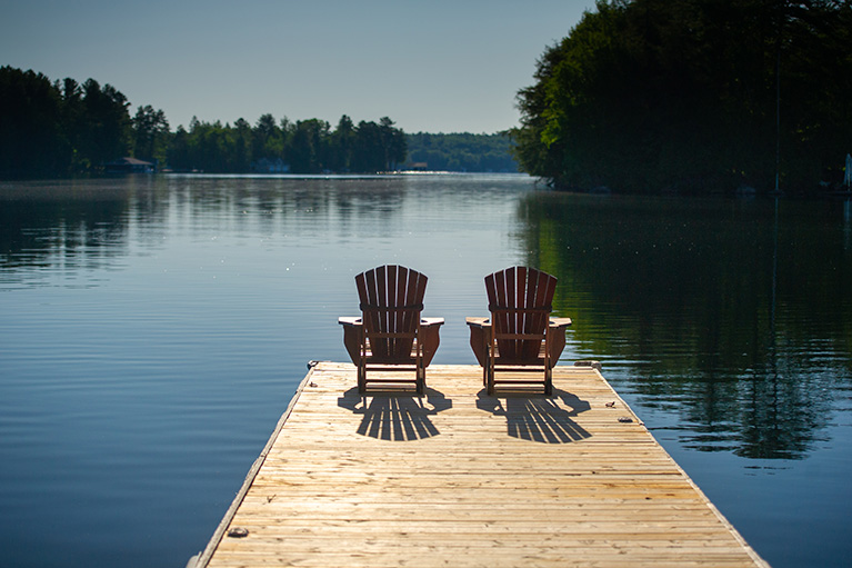 Two chair in front of a river