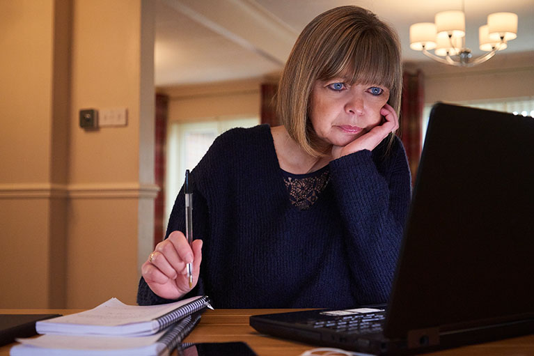 Woman showing stress staring at computer screen