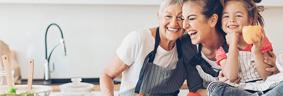 Three generations of women cooking together 