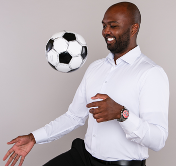 Daniel Ocoro (Jeff Wiebe Treasury Advisory Team) kneeing a soccer ball in mid-action.