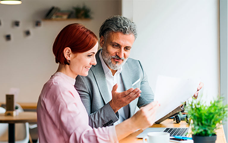 A woman and a man looking at a document together