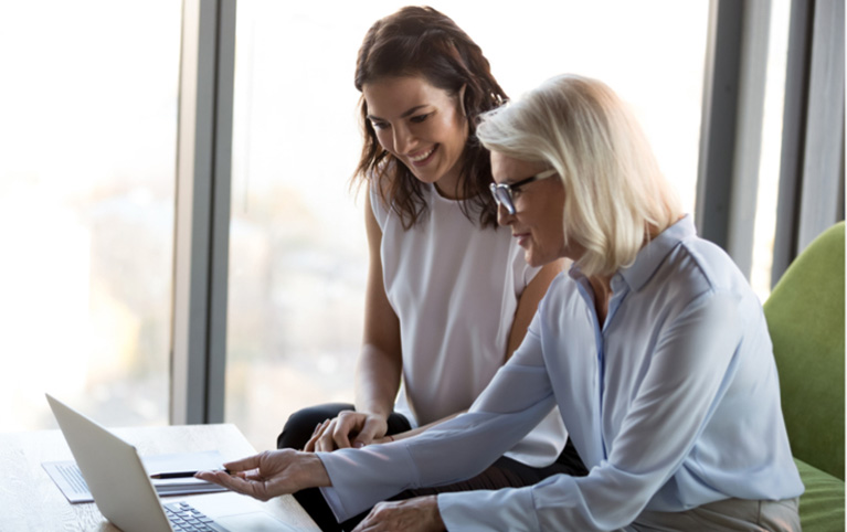 Two women looking at a laptop together