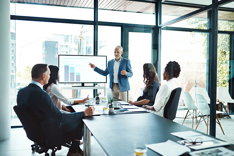 People in a meeting in a glass office.