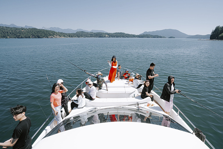 image of the team sitting in the front of the yacht.