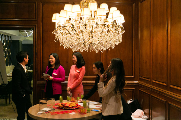 Four women and a man in a room.