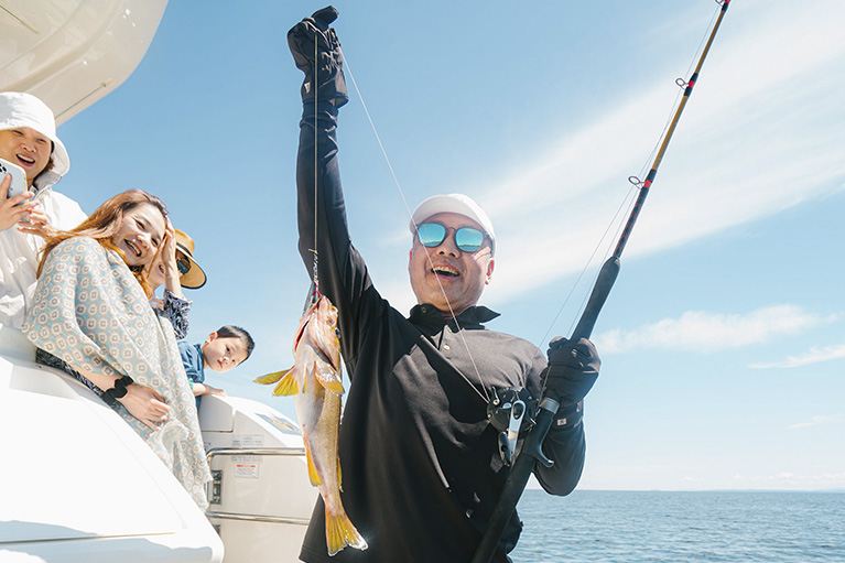 image of johnny cheung holding up a fish he caught.