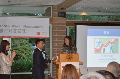Johnny Cheung and two women taking on a stage.