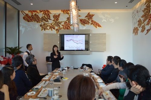 Tina Yang talking at the Miku event in front of a table.