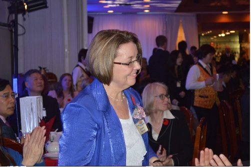 A woman smiling at the BC liberals winter celebration.
