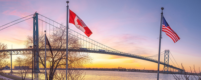Image of a Canadian flag and an American flag