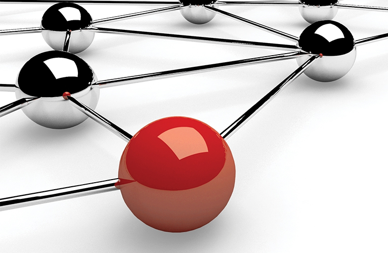 Interconnected silver chrome colored balls with a red ball.