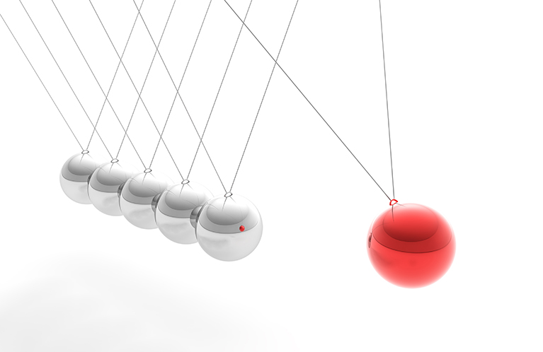 Several metal balls hit each other.