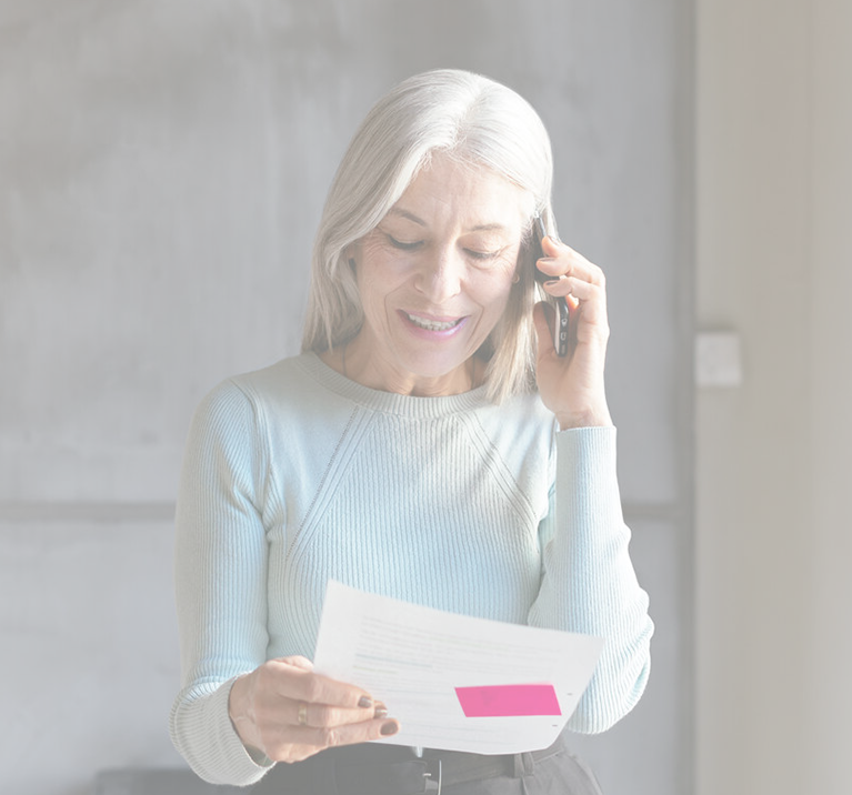 woman on the phone while reviewing her performance reports from Legatum Wealth Advisors