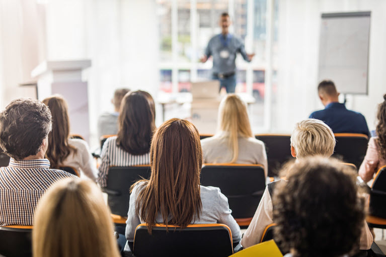 A man giving a presentation to a group of people. 