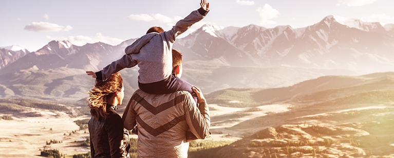 A family looking at mountains thinking about their savings strategies.