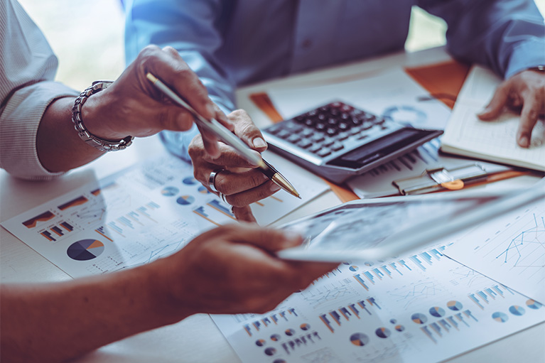 A man and a woman work on financial documents.