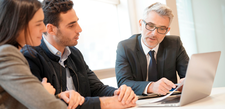 Wealth Advisor reviewing documents with his clients.