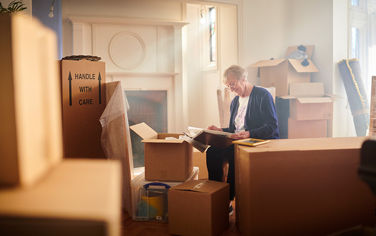 Image of a widow packing up her boxes. 