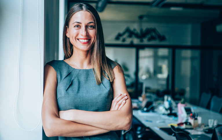 Professional individual in business attire with arms crossed—depicting high-income earners seeking tax optimization and investment management.