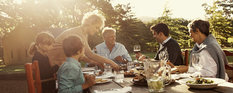 Family sharing a meal outdoors, symbolizing the role of financial planning in creating stability and meaningful moments together.