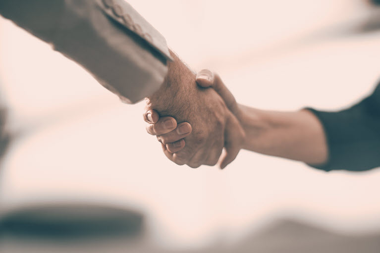 image of two people shaking hands